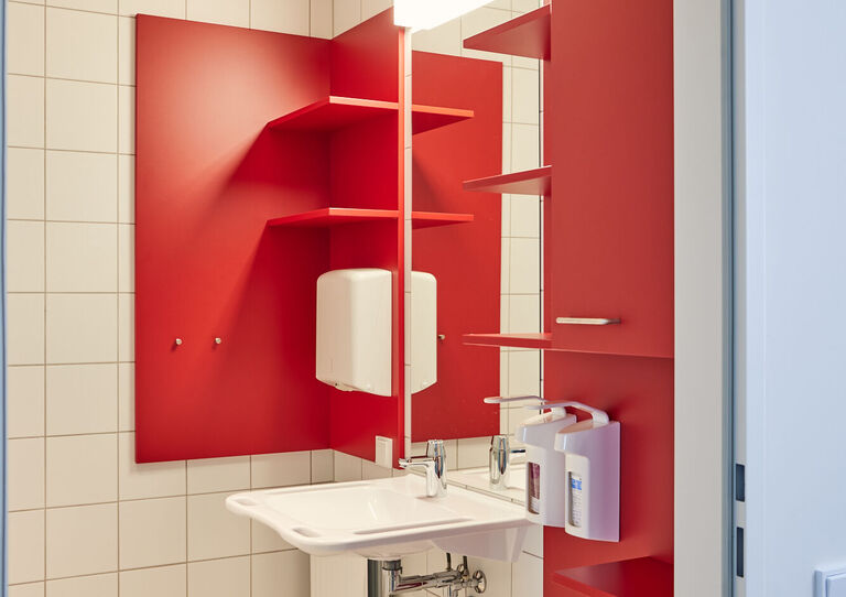 Ein rotes Badezimmer im Stadtheim