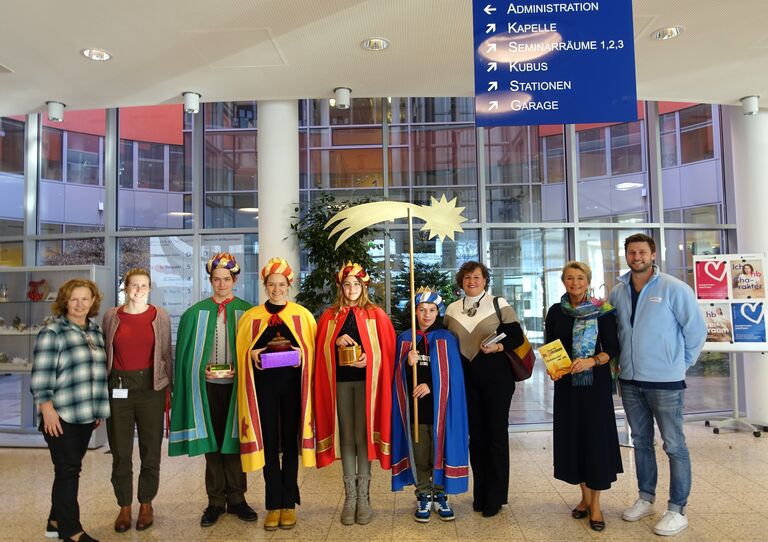 Sternsinger*innen besuchen das Haus der Barmherzigkeit Tokiostraße und haben sich mit Mitarbeiter*innen aus dem HB zu einem Gruppenfoto formiert