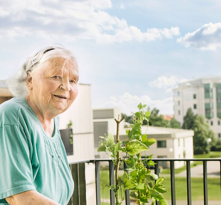 A resident, an elderly lady, on a balcony.