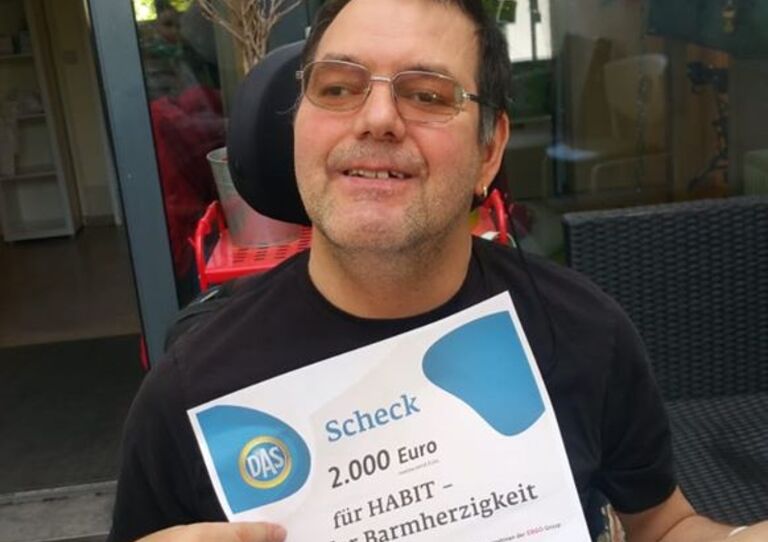 Kunde Richard mit dem Spendenscheck.